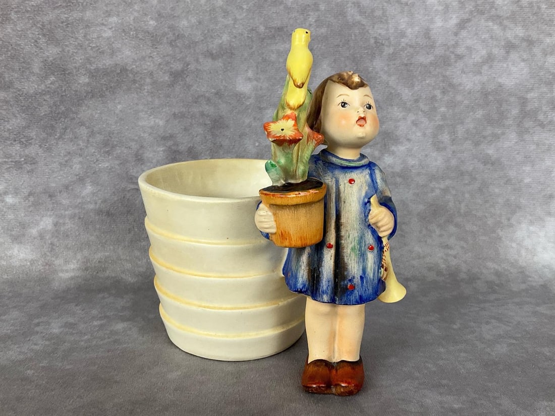 Contratulations with Pot: Extremely rare example of Hum 17 with attached post/vase produced circa 1935. Stamped TMK 1 crown, but with copyright date, mold number, and M.I. Hummel signature all being absent. Sticker on undersid