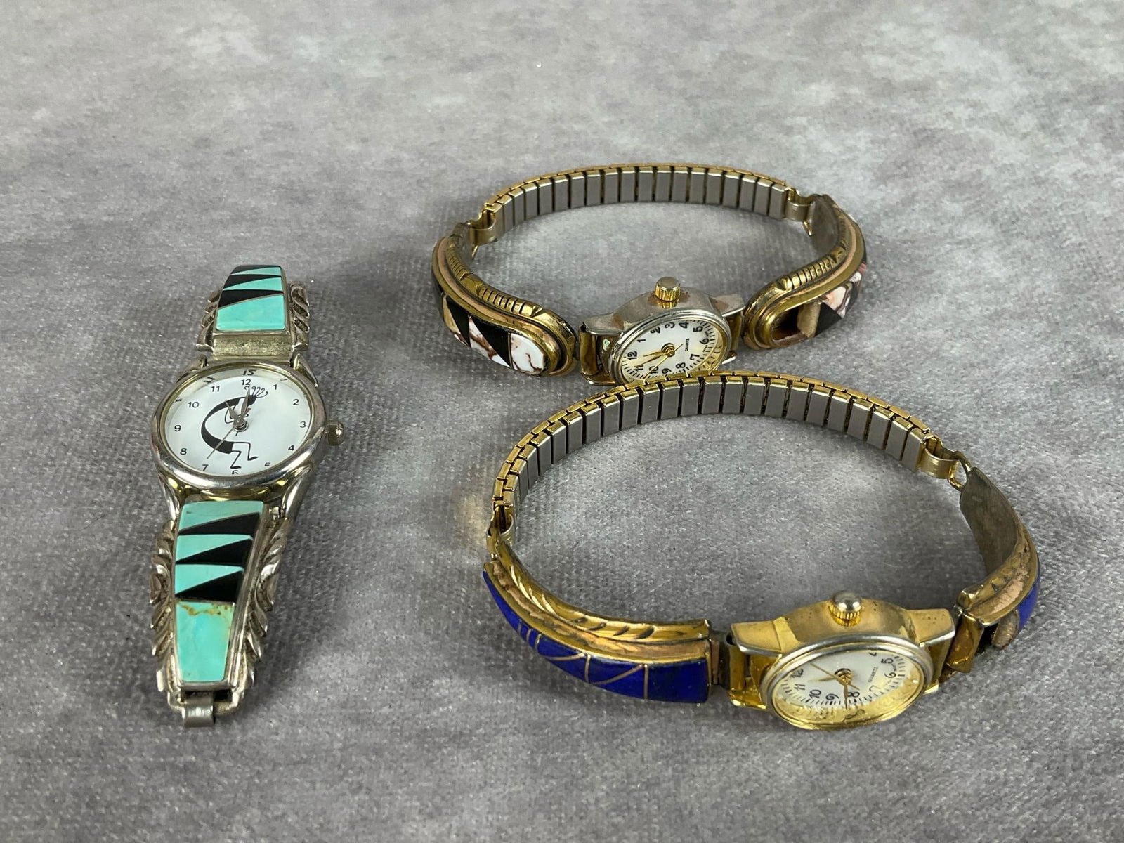 Native American Sterling Wristwatches: All three are sterling bands. One with azurite is missing a stone. It is signed N. Juan. Second is marked for J. Begay with onyx and jasper. Missing a stone. Third with turquoise and onyx is stamped s
