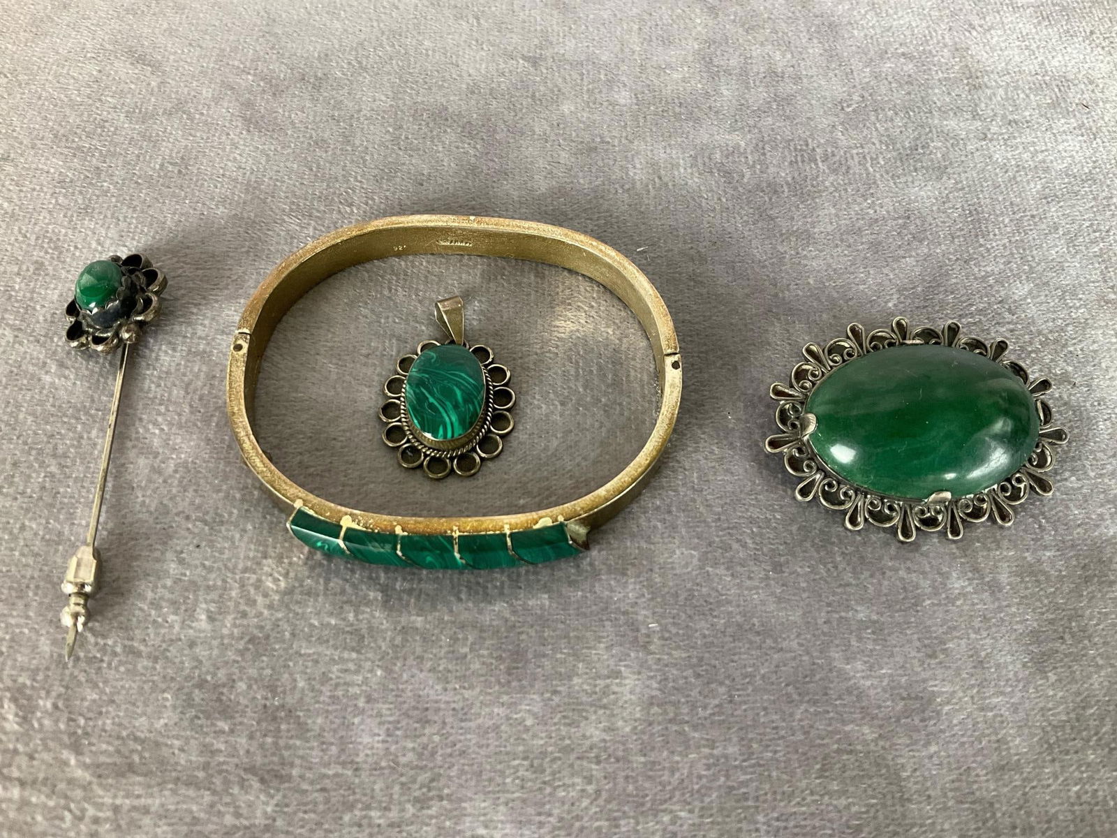 Mexican Sterling Jewelry: Hinged bracelet is stamped 925 Mexico with malachite. Brooch is marked Mexico 925. Malachite pendant is marked the same. Stickpin is not mark.