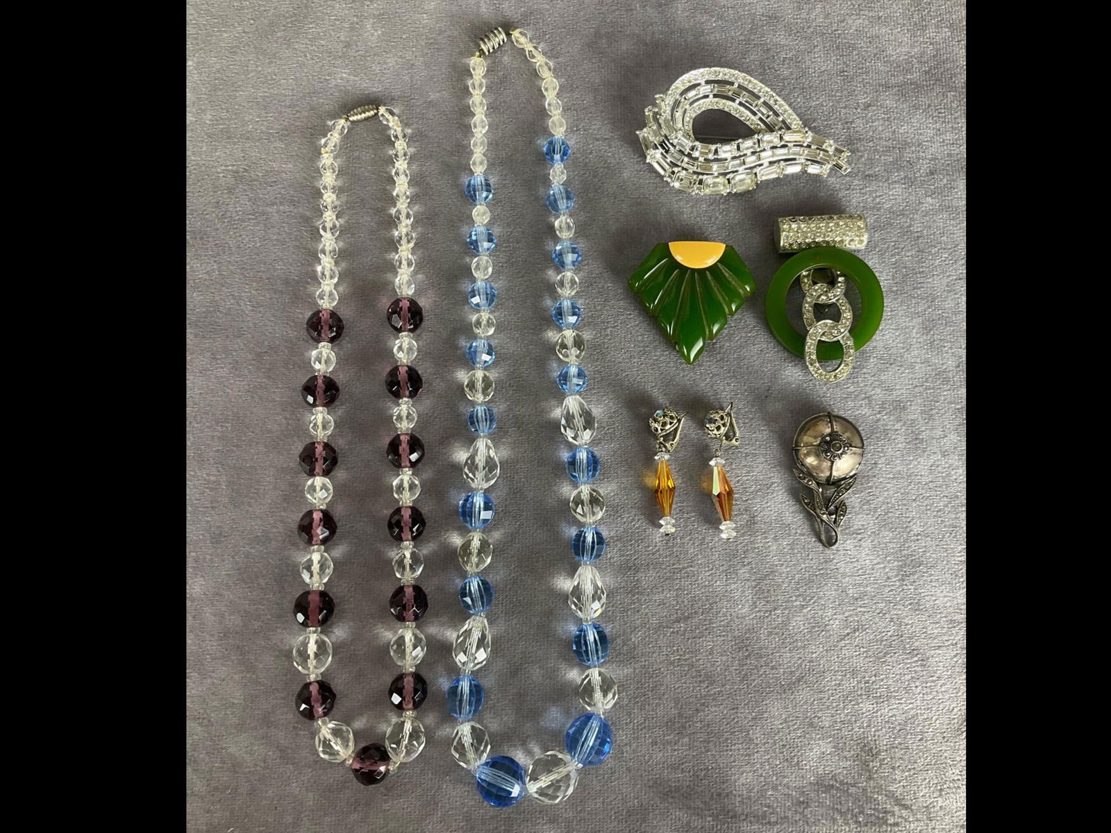 Art Deco Jewelry & More: Green Bakelite dress clips in two different styles, rhinestone brooch with missing stones, sterling dress clip with marcasites, clip earrings with iridescent beads, and two glass bead necklaces. Good