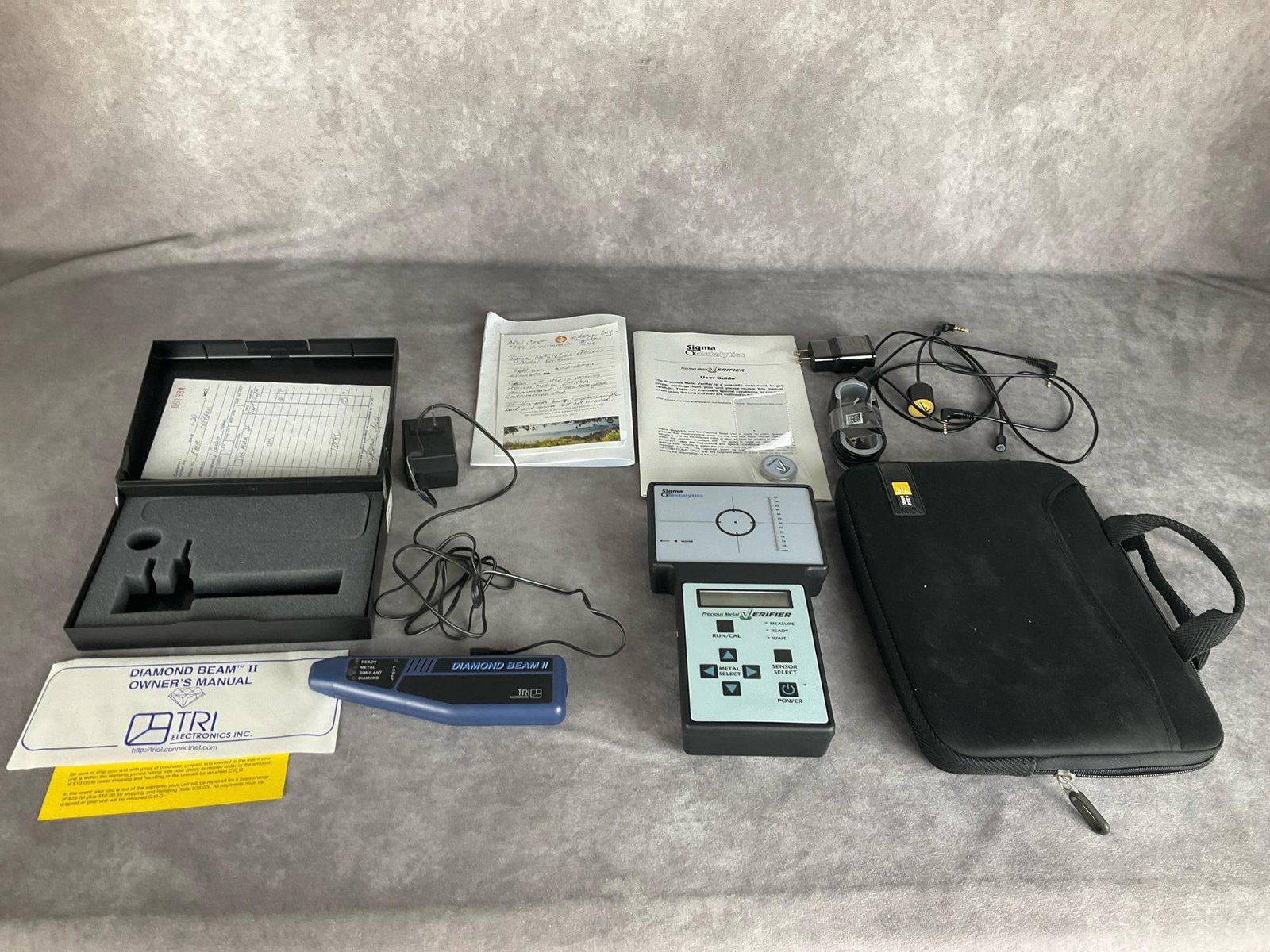 Precious Metals & Diamond Testers: Sigma Metalytics Precious Metal Verifier. Model#SM1501. Includes the tester, manual, Large, Small and Bullion external wands, calibration weight and USB to micro USB cord. A Samsung adapter and Case L