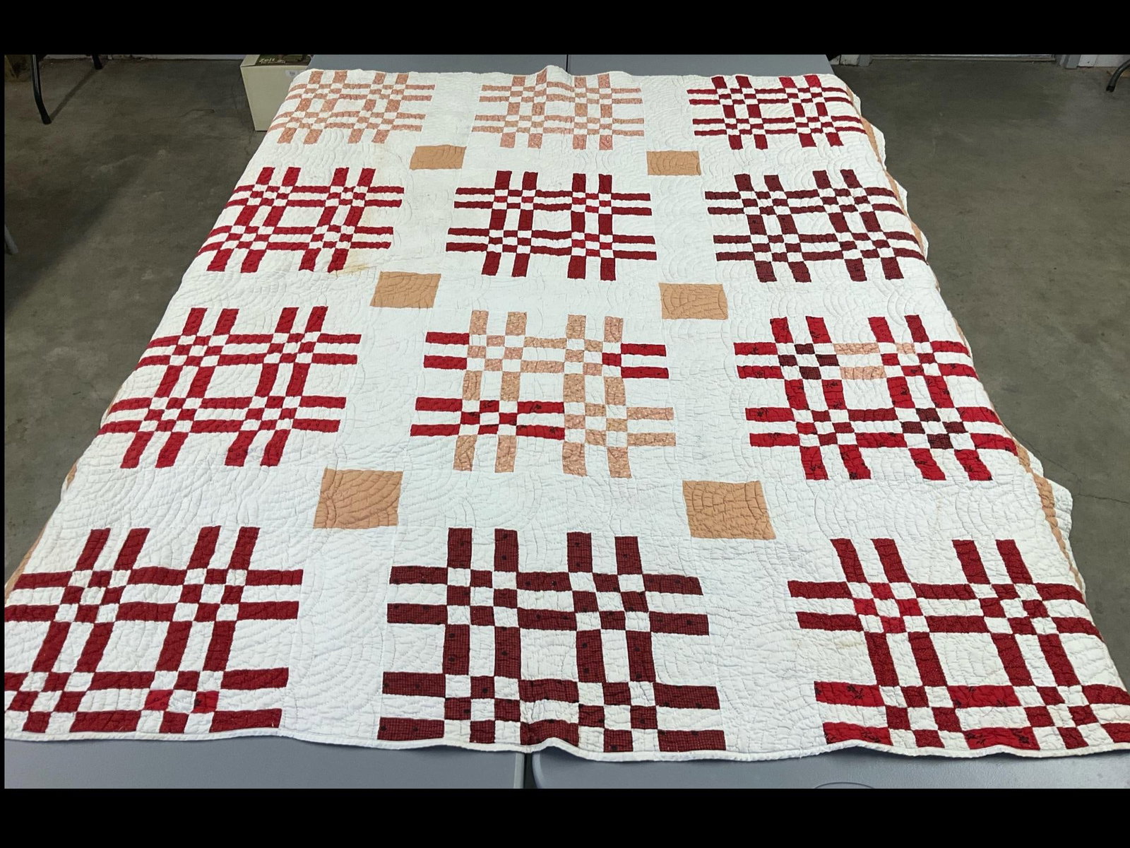Hand Stitched Checkerboard Quilt: Checkerboard nine patch variation. Some of the reds have faded to tan. Some rust colored stains throughout. Machine stitched edge. 67 x 80 inches.