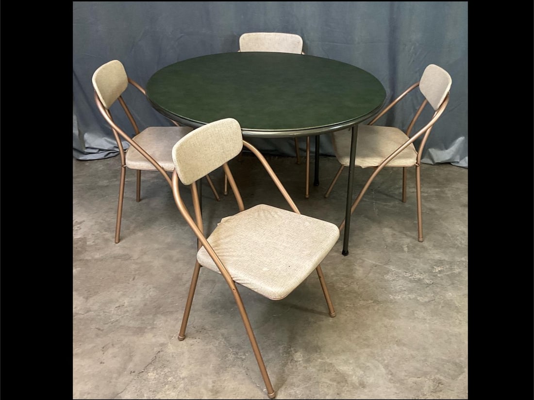 Card Table & Chairs: Round folding table with a green and copper colored vinyl top, good condition except leg caps are missing and taped. Four folding chairs made by Hamilton Cosco. Vinyl seat covers are loose but otherwi