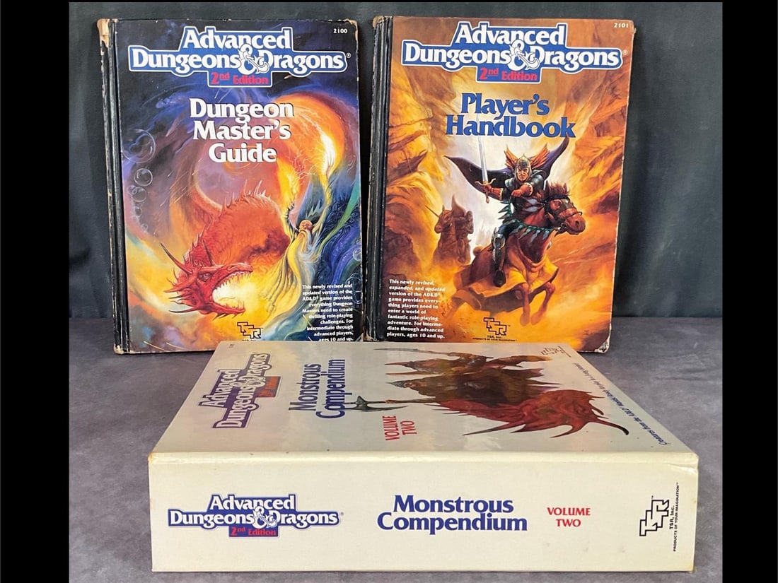 Dungeons and Dragons: Advanced second edition Player's Handbook, Dungeon Master's Guide and Monstrous Compendium from 1989. All have been used but are in overall fair to good condition.