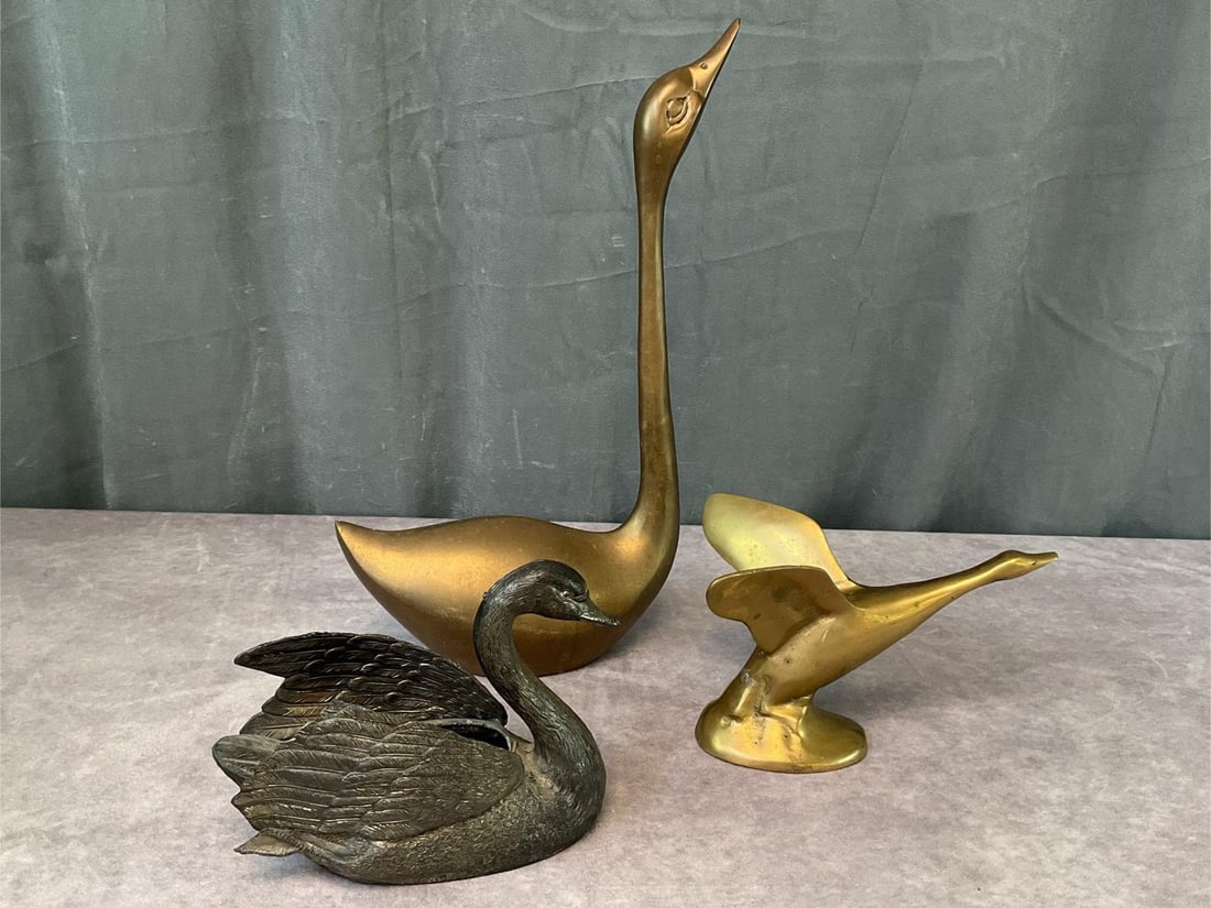 Decorative Brass Birds: Two brass and one metal swan, the long neck brass goose is 15.25 inches tall. Wear and patina to all.