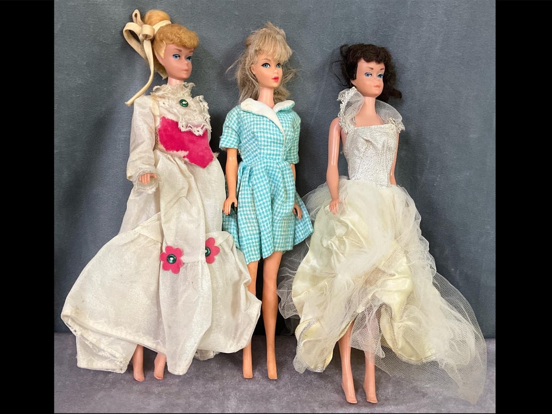 1960's Barbie and Midge Dolls: Barbie is marked Mattel 1966 Made in Japan. Two Midge dolls are marked Midge Barbie possibly 1962. All three dolls are 11 inches tall and are in fair to good played with condition. Clothing is in fair