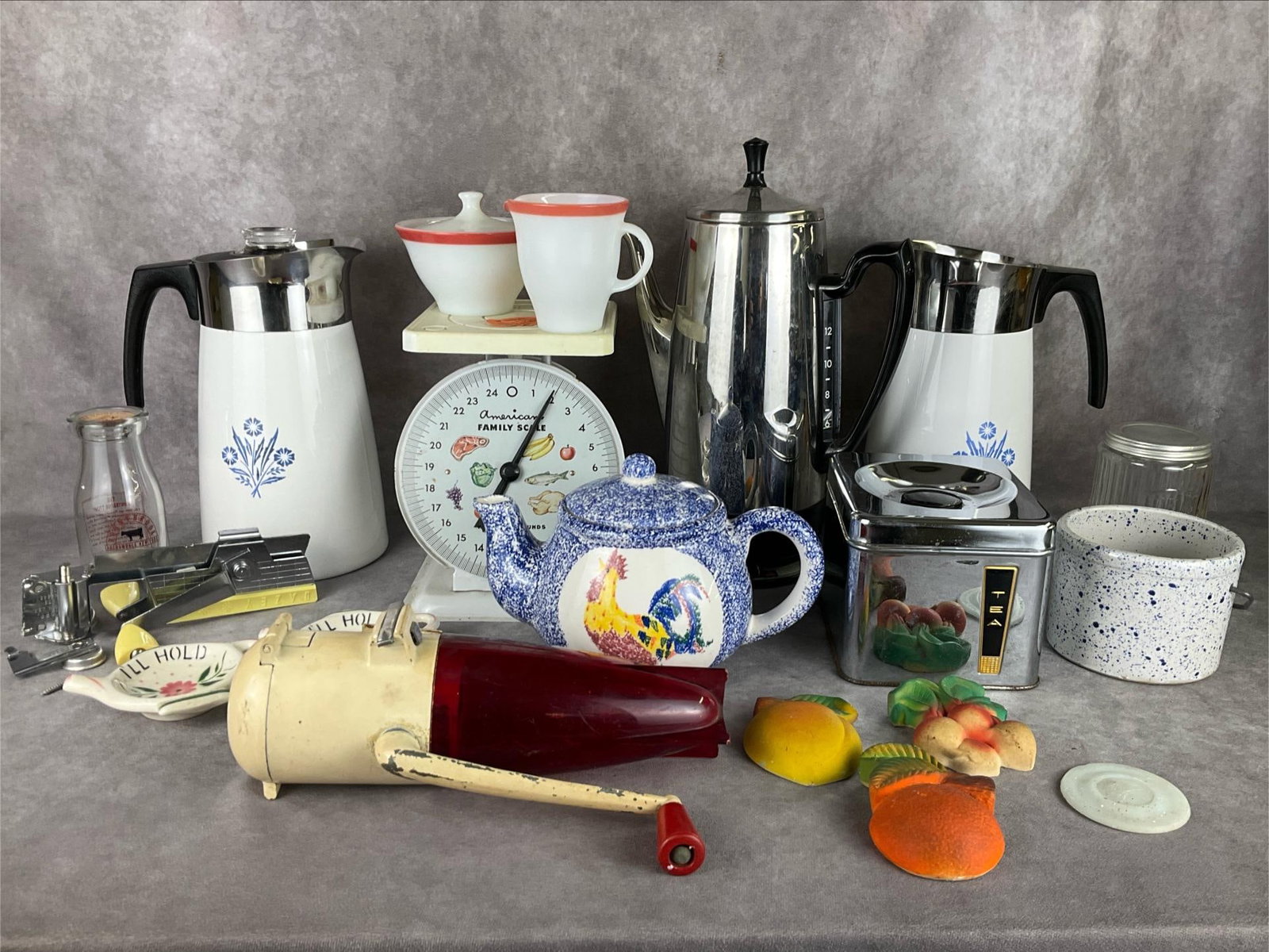 Vintage Kitchen Collection: Dazey wall mount ice crusher, Dazey yellow wall mount can opener, GE coffee percolator with parts and cord, American Family scales, chalkware fruit and vegetables, Corning cornflower stove top percola