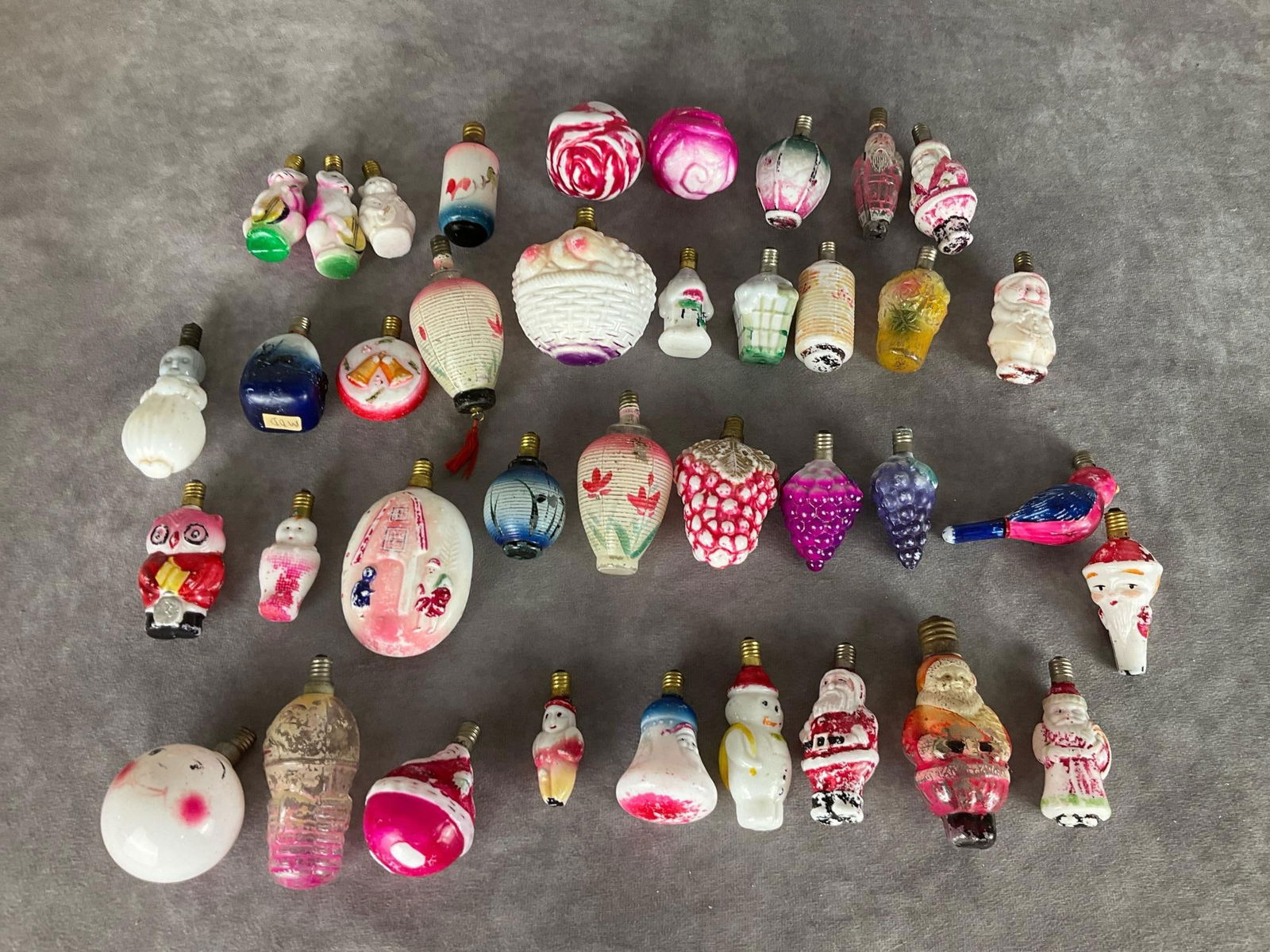 Glass Christmas Bulbs: Most marked Made in Japan. Forms include roses, Santa, a dwarf from Snow White, owl, cat with fiddle, Japanese lanterns, grapes, fruit basket, snowman, and more. Some are milk glass and some clear. Ma