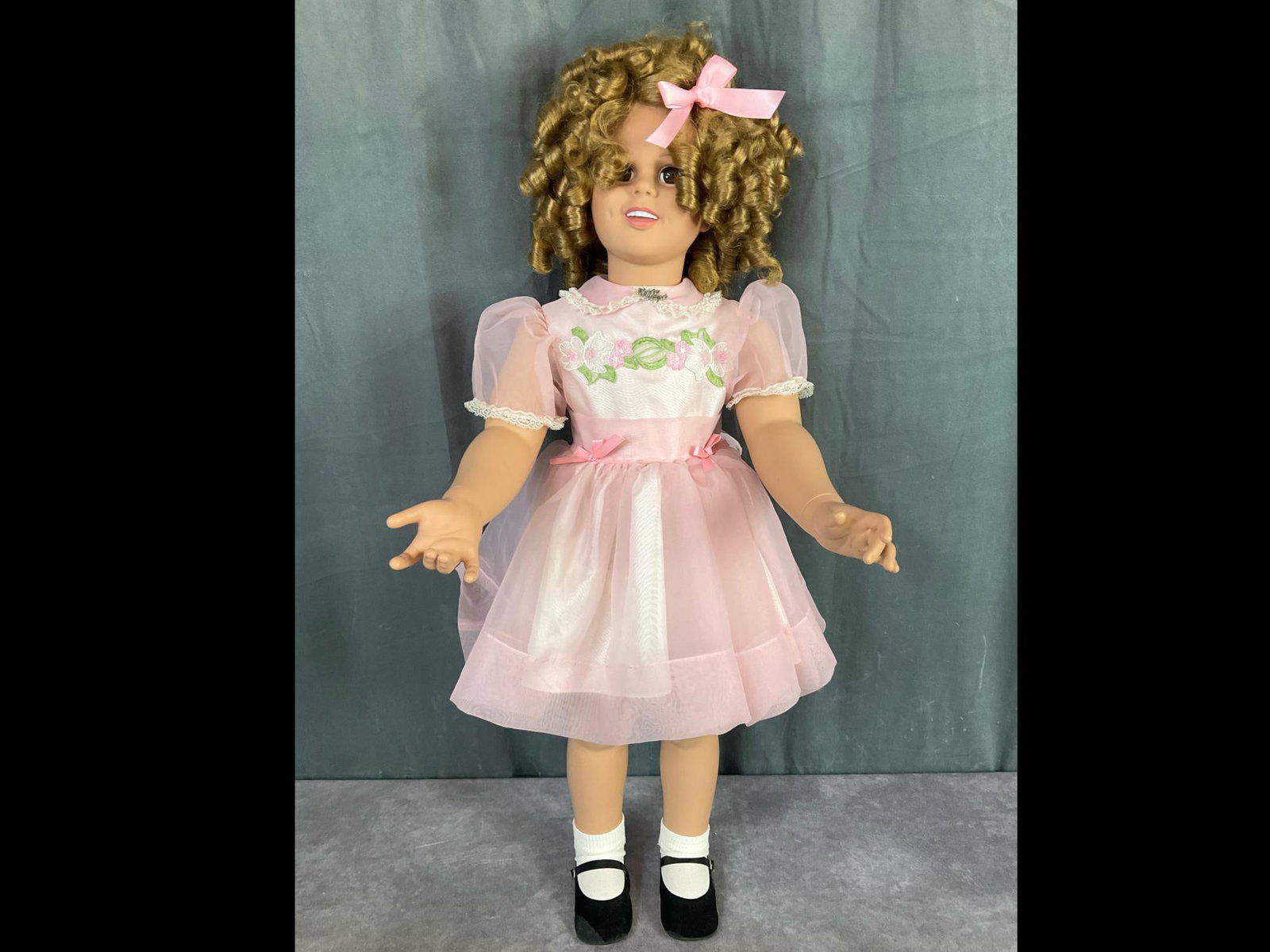34 Inch Shirley Temple Doll: Hard plastic. Made by MBI. Felt is worn on shoes, a few light stains to clothing, and scuffs on plastic. Overall good condition.