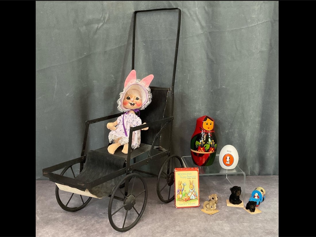 Children's Toys and Games: Folding metal doll stroller measuring 19.5 inches tall to top of handle. Dusty but in good condition. Annalee ‘90 rabbit, 7.5 inches tall in good condition. Set of Russian nesting dolls in good cond