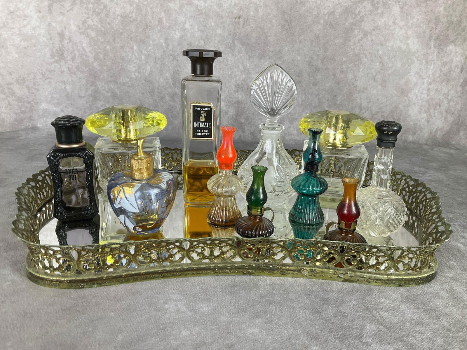Perfume & Vanity Tray: Two Versace Yellow Diamond bottles, one with a tiny amount of perfume left. Partial bottles of Revlon Intimate and Anna Sui. One crystal perfume bottle and one sterling capped over cut crystal bottle.
