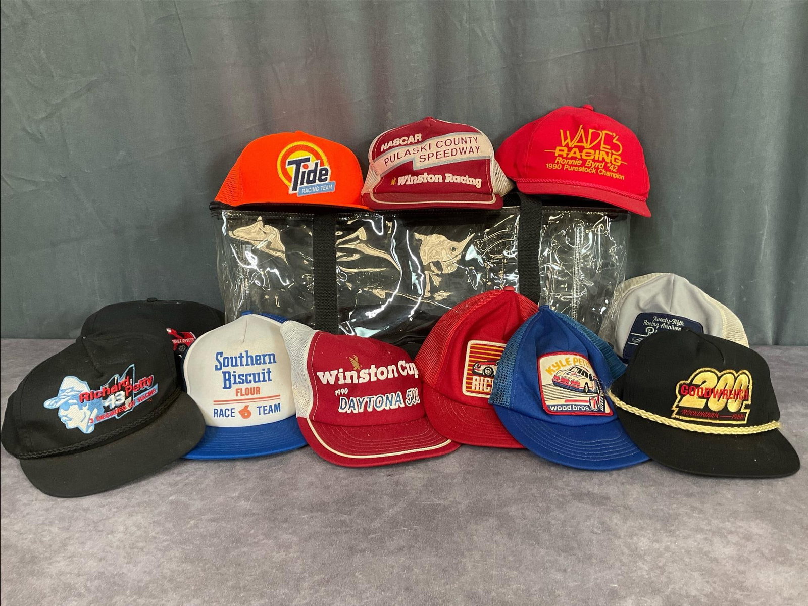 1990's NASCAR Racing Hats: Local Pulaski VA Speedway, Richard Petty 25th racing anniversary, Daytona 500, and more. Plastic hat bag included, 21 inches long x 8 inches tall. Signs of wear, staining, and dry rot to foam on truck