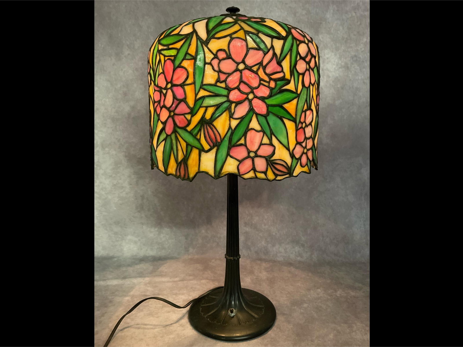Cherry Blossom Leaded Glass Lamp: Early 20th century. Three candelabra bulbs. Push button light switch on the base. Weighted base. Only the cap under the finial is marked with the number 5227. Leaded glass dome shade has quite a few s