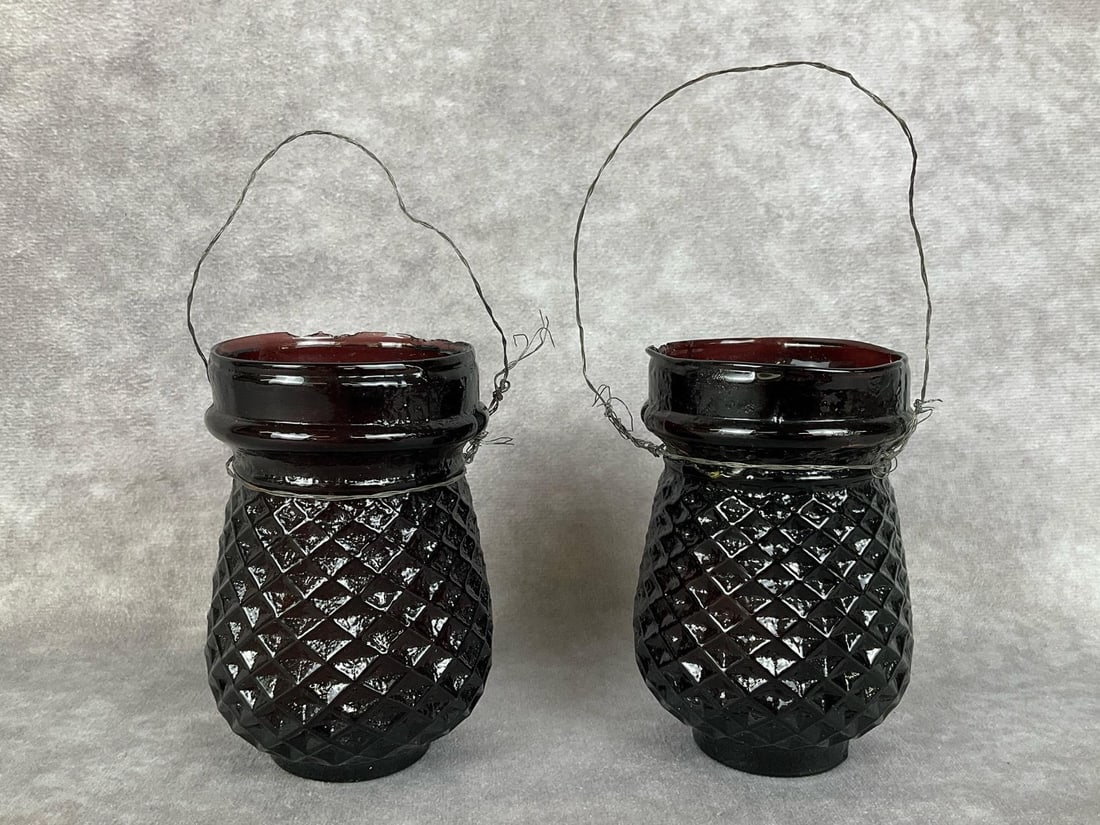 Victorian Amethyst Glass Fairy Lights: Both in pressed diamond pattern. One embossed 158, other 162, on bottoms. Both have partially used candles inside, chipped rims, and one has several severe cracks along upper; one section has been rep