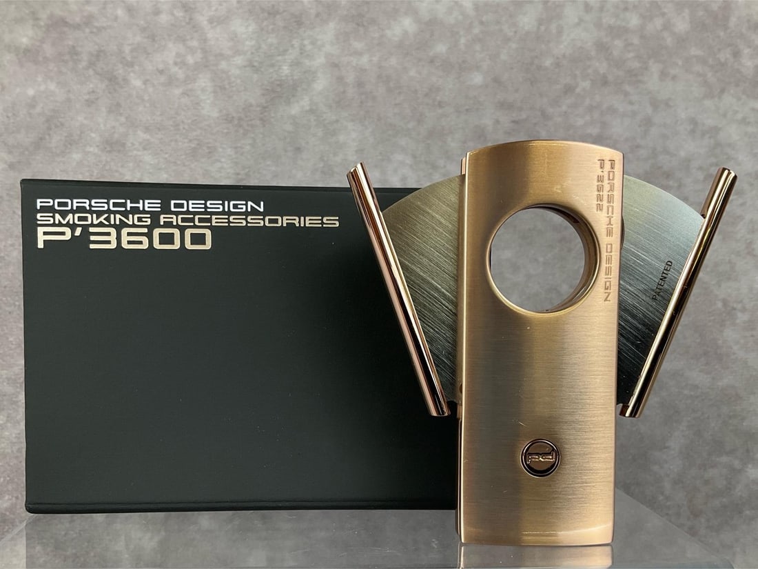 Porsche Cigar Cutter: P'3600 double blade Porsche Design Smoking Accessories cigar cutter in rose gold. Like new in original box. Length of 3.5 inches.