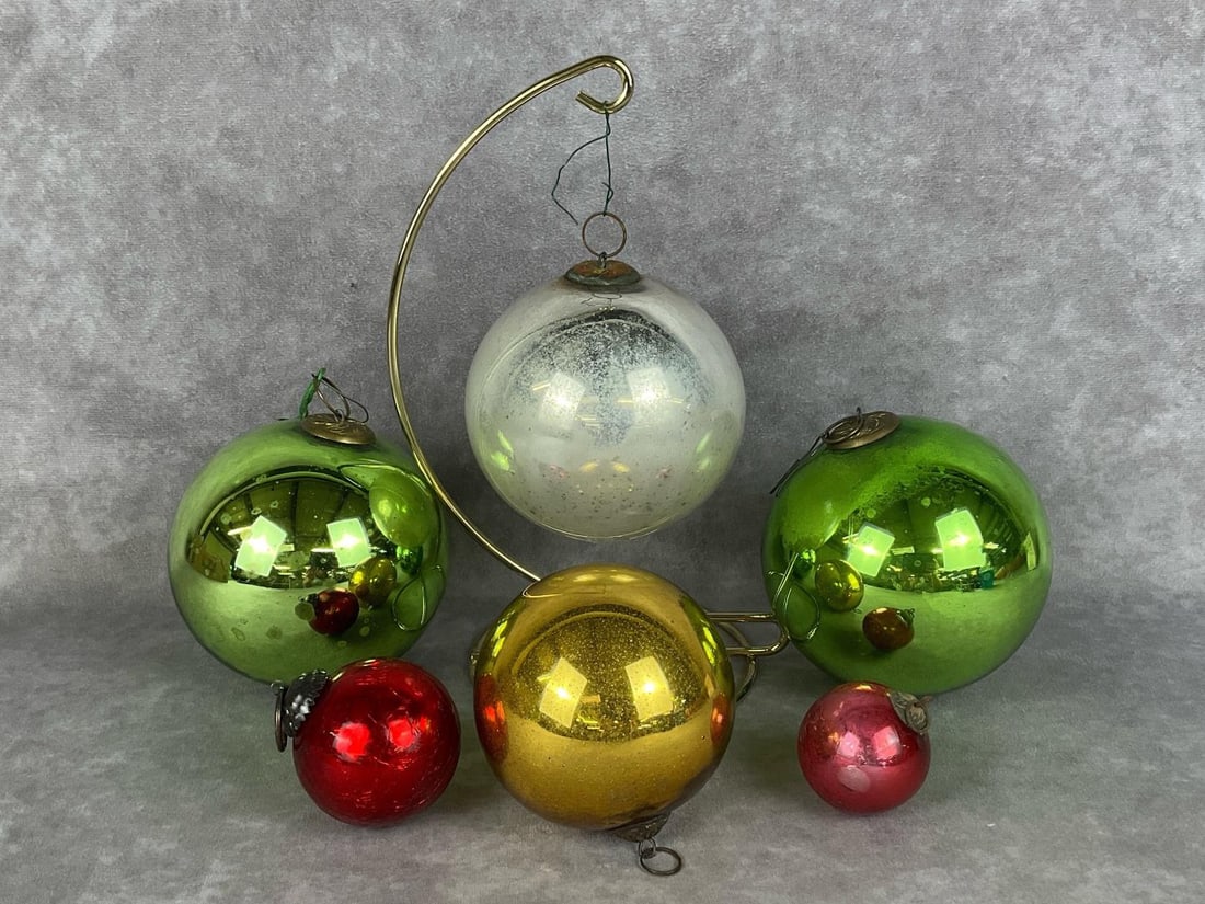 Six Kugel Glass Ornaments: Two large green, one large frosted silver/white, medium gold, small crackle red, and a extra small 1.75 inch cranberry. Unsigned, from various time periods. Some mottling and age spots. Largest is 4 i