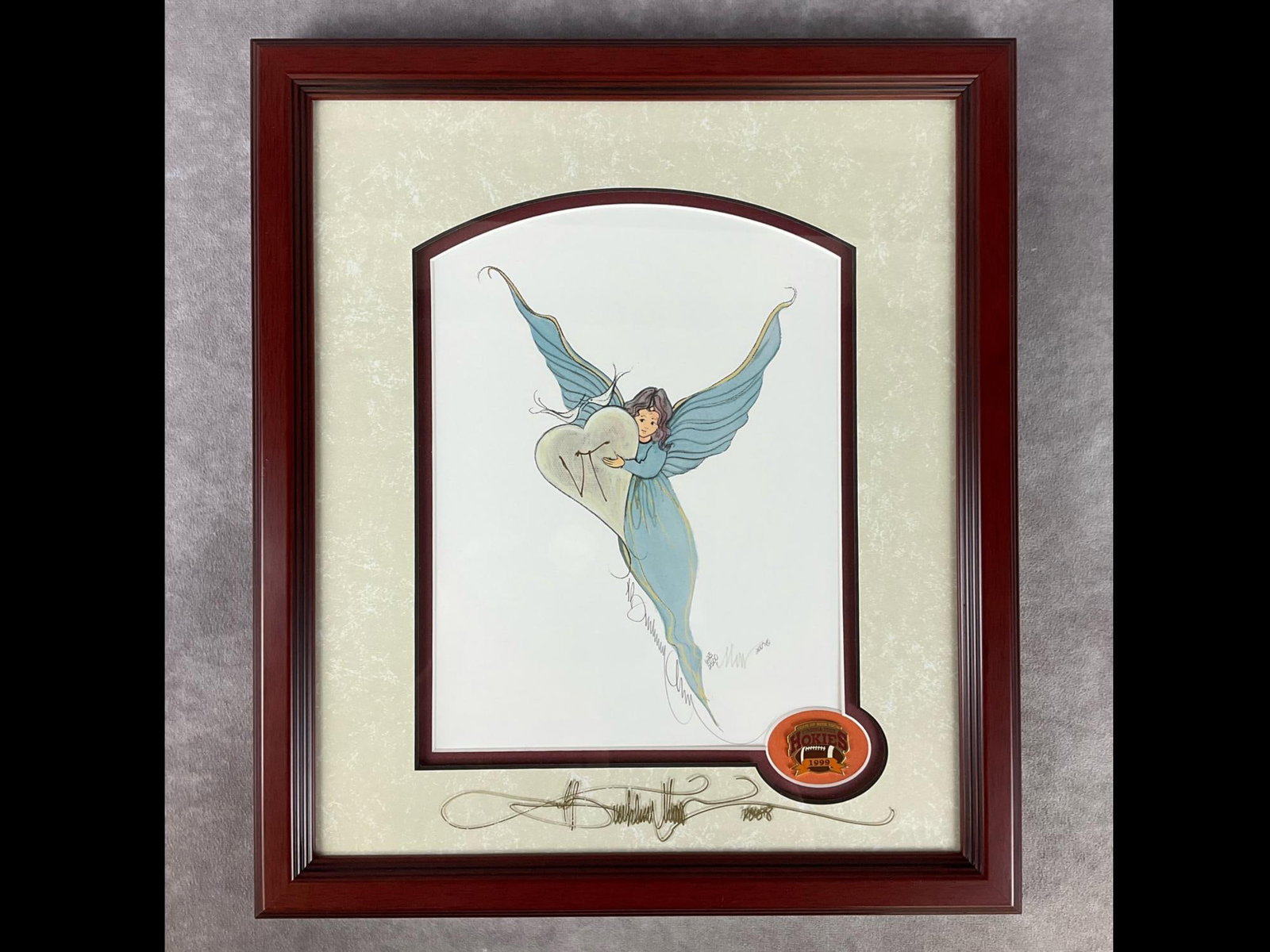 P. Buckley Moss Framed Print: Hokie Angel. Limited edition No. 623/2500, signed and dated 2007 on print, as well as signed and dated 2008 in gold pen on glass by artist. VT in gold ink written on glass over heart, and there is a H