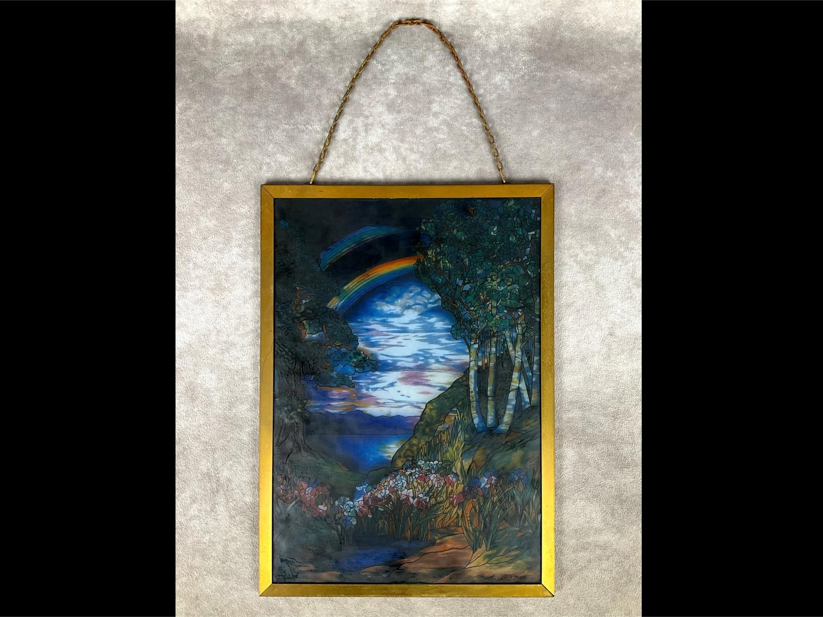 Tiffany Rainbow Art Suncatcher: Double Rainbow landscape originally by Louis Comfort Tiffany, produced in the USA by Glassmasters. 9.5 x 13 inch metal frame with chain for hanging containing the faux stained glass decal panel. Moder