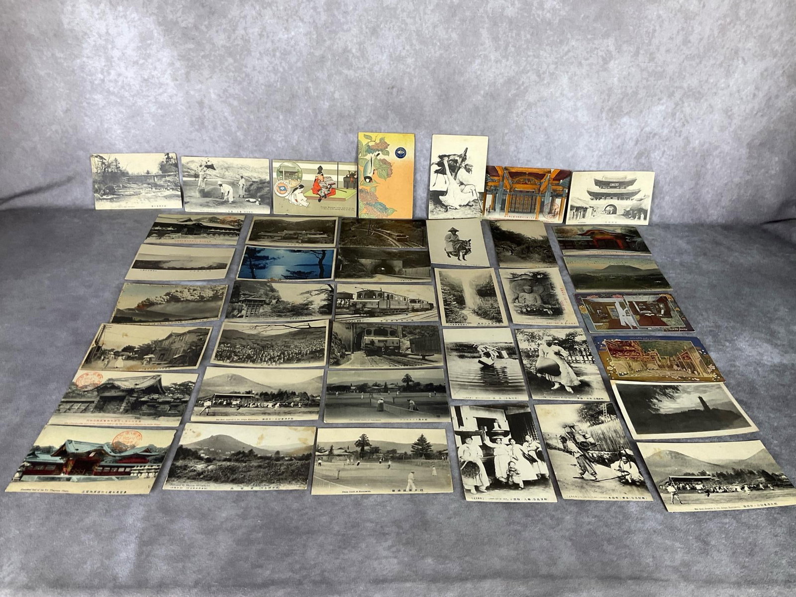 Early 20th Century Japanese Postcards: Most unused. Printed by S. Kuwada and Sons, Ohkawa, etc. Some brown stains but overall still in decent condition.
