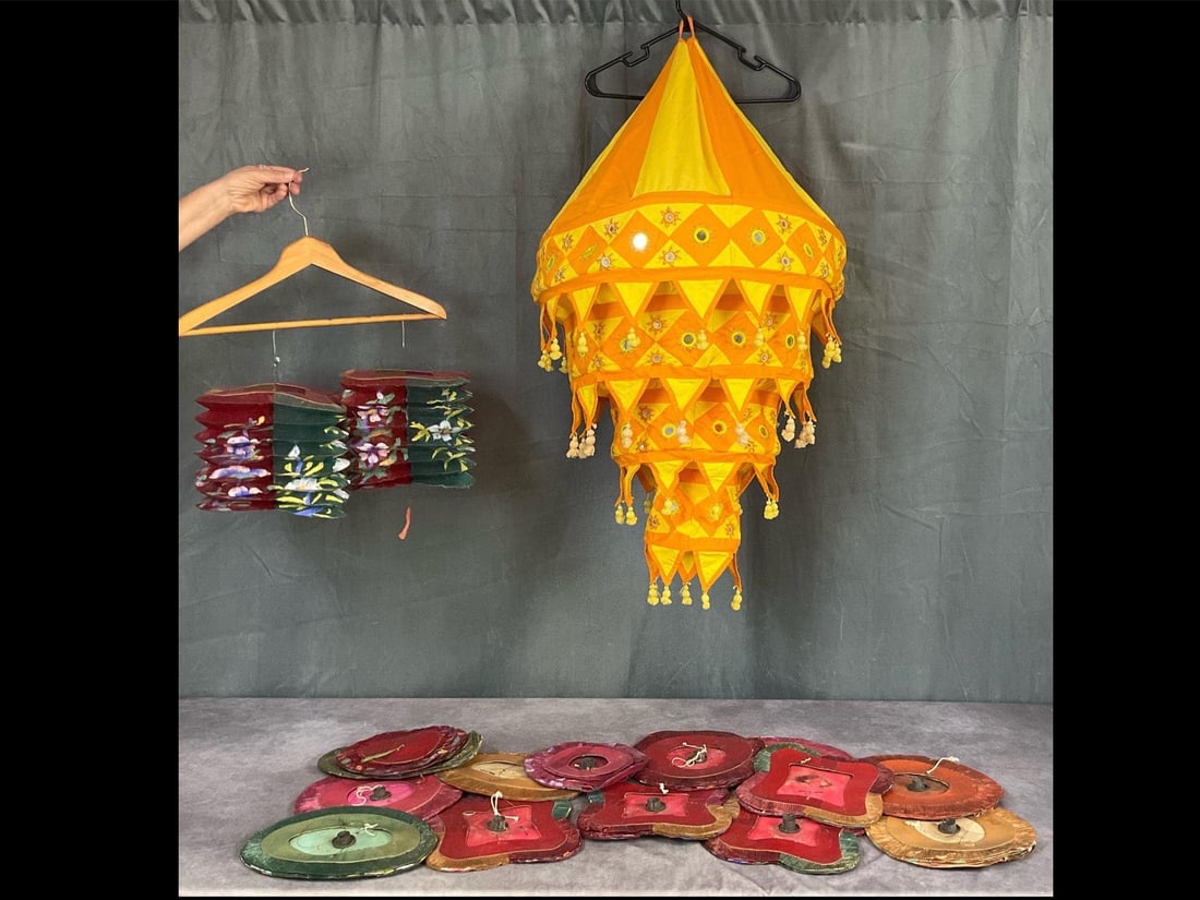 Cloth and Paper Lanterns: Large Indian yellow and orange cotton decorative lantern with small mirrors to reflect light. Along with 16 vintage Chinese hand painted accordion paper lanterns. Cloth is approximately 24 inches at t