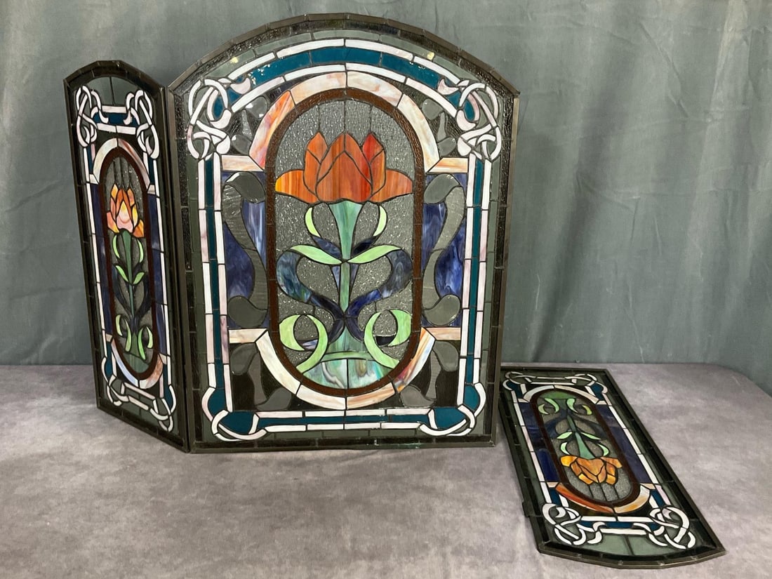 Leaded Glass Tri-fold Screen: Medieval rose design. One small blue glass insert is cracked. Has a few other cracks that are less noticeable. One side has damaged hinges and needs replaced. Some verdigris to metal from moisture dam