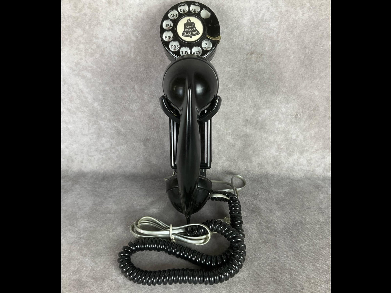 Northern Electric Space Saver Phone: Heavy metal base with plastic receiver. Receiver is marked Northern Electric made in Canada. Rotary dial on top with bell systems decal. Back of dial has modern sticker dated 1992. Untested, 10.75 inc