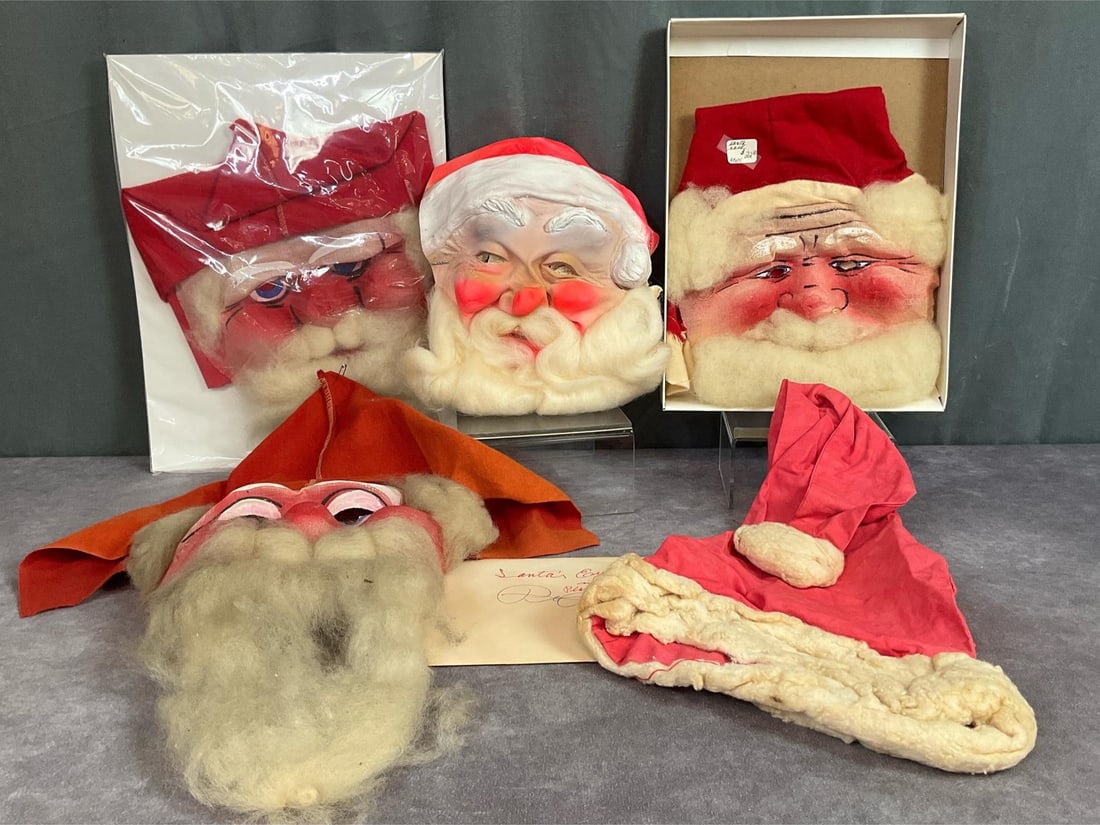 Santa Masks and Hat: 1940s cloth and wool mask, Brooklyn NY, 21 inches long x 9 inches wide. Two 1950s masks, faded Santa hat, fragile rubber mask that has dry rotted, and an envelope with fibers for Santa's eyelashes. Al