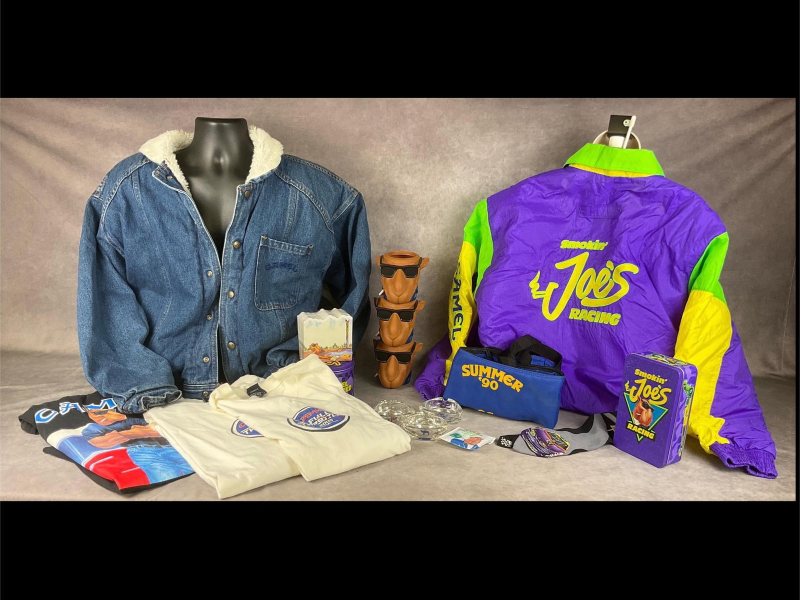 Camel Memorabilia: Three Joe Cool can coozies, notepad, three ashtrays, pool cue bag, portable ashtray, two match cans with unopened matches, two large/extra large long sleeved shirts, one short sleeved shirt. Denim Jac