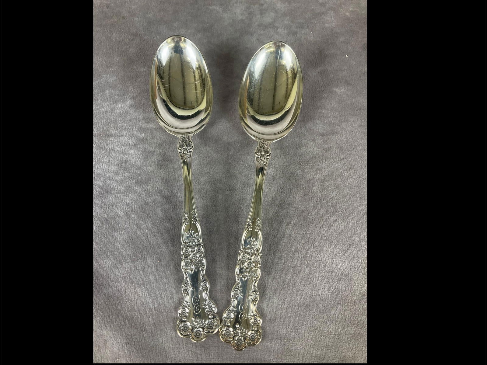 Gorham Buttercup Sterling Serving Spoons: Group of two. Marked sterling. Measures 8 and 1/4 inches long. Light scratches and tarnishing. Monogrammed with E. 3.86 ozt silver.
