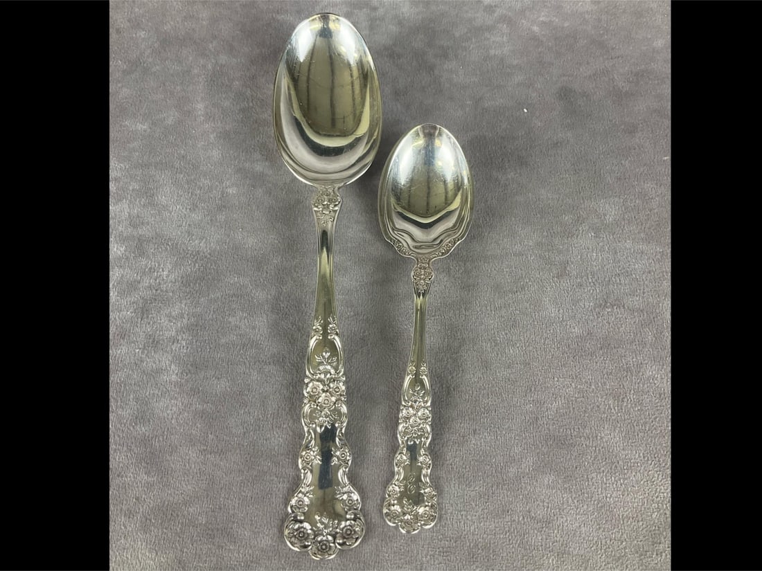 Gorham Buttercup Sterling Spoons: Group of two. Marked sterling. Largest measures 8 and 1/2 inches. Smallest measures 6 inches long. The smaller spoon is monogrammed on the front, the larger spoon is monogrammed on the back. Light scr