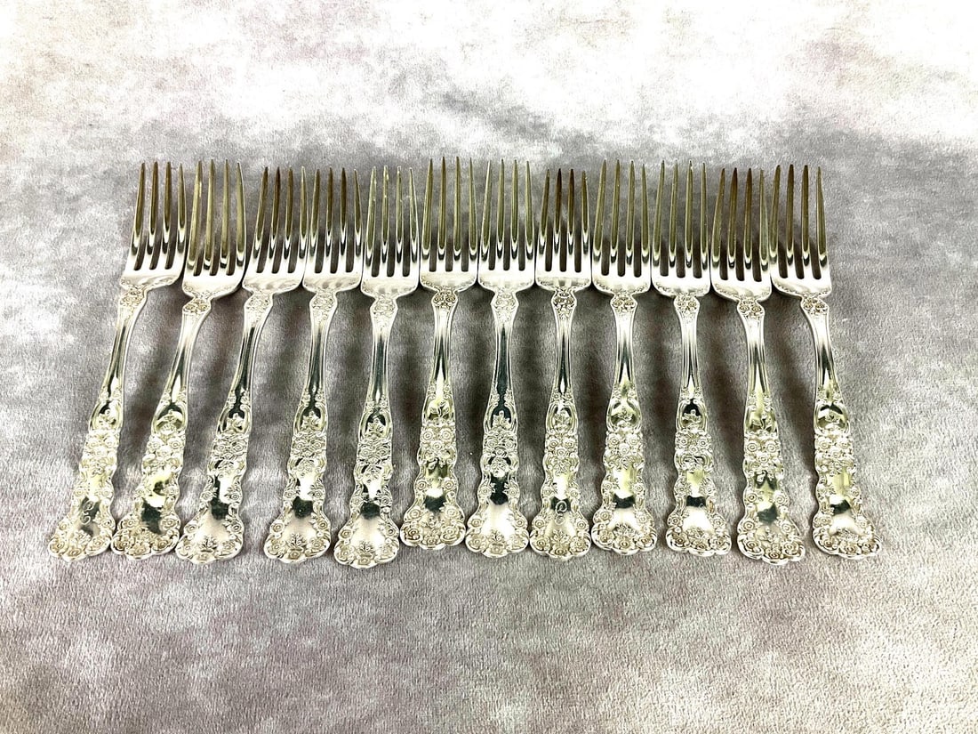 Gorham Buttercup Sterling Dinner Forks: Group of 12. Marked sterling. Measures 7 inches long. Light scratches and tarnishing. Two are monogrammed on the front, and six are monogrammed on the back, four have no monogram. 16.39 ozt silver. So