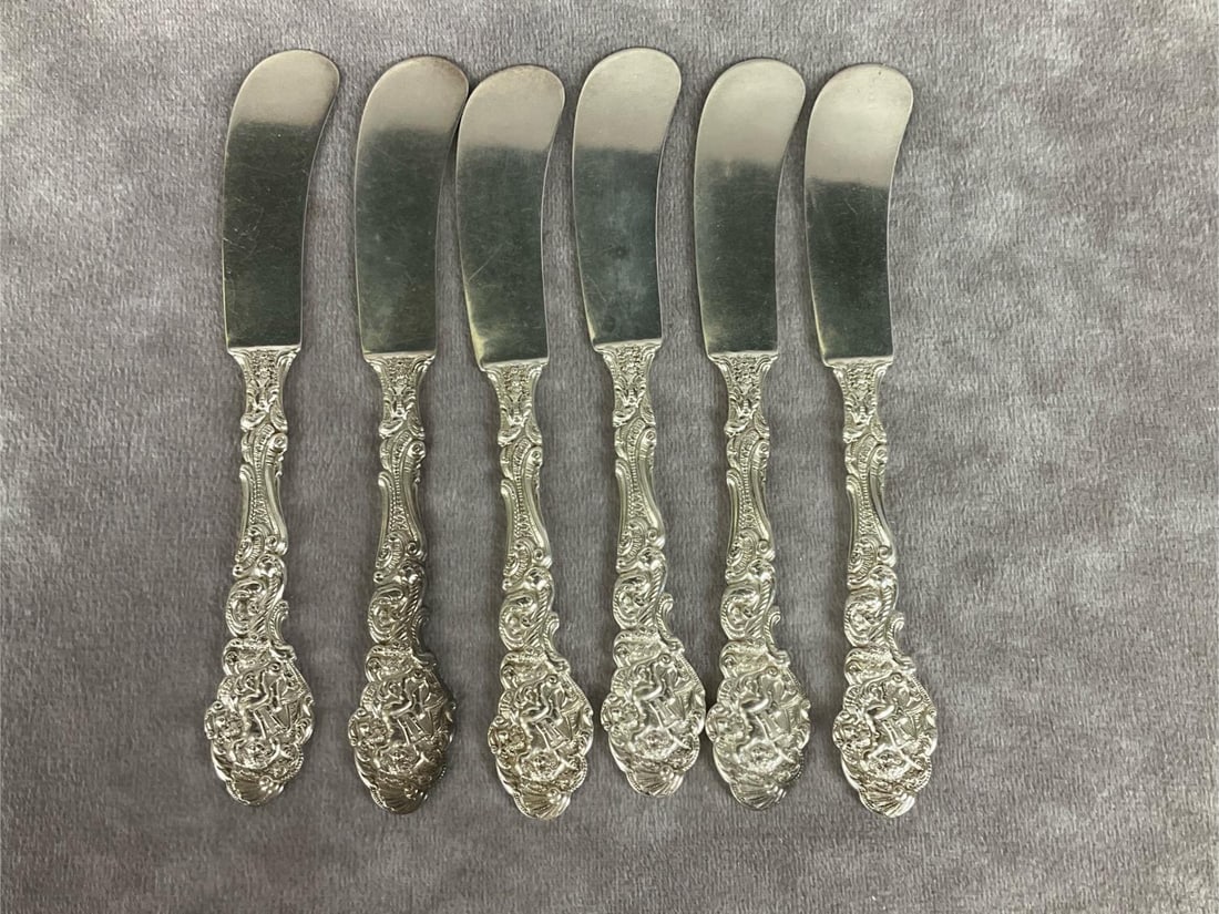 Gorham Versailles Sterling Flat Handle Butter Spreaders: Group of six. Marked sterling. Measures 6 inches long. Light scratches and tarnishing. Monogrammed. 4.88 ozt silver.