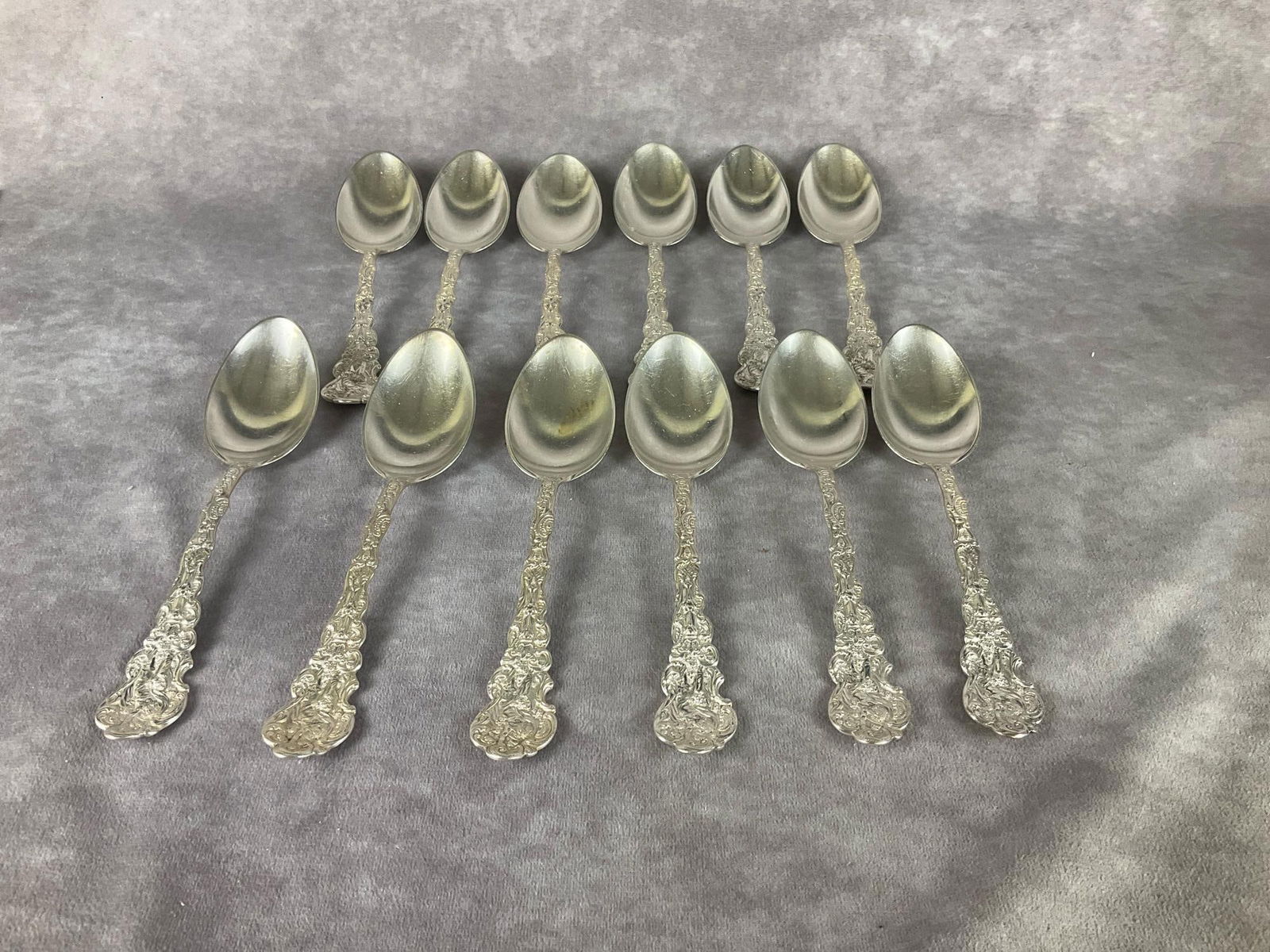Gorham Versailles Sterling Dinner Spoons: Group of twelve. Marked sterling. Measures 7 inches long. Light scratches and tarnishing. Monogrammed on back of handle . 19.08 ozt silver.