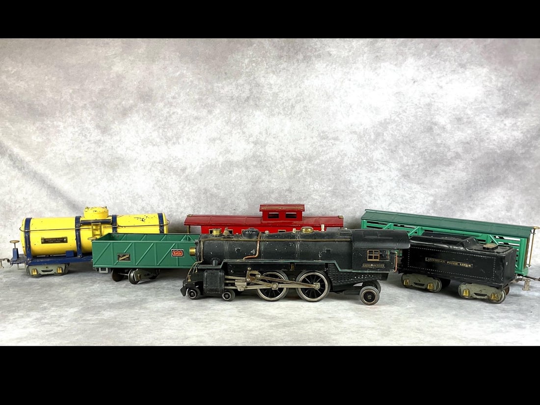American Flyer 4680 Train Set: 1930s. Standard gauge freight set with black engine, green box car, yellow tank, green gondola, and red caboose. Untested, minor paint loss, and scratches apparent on some of the cars. Green cars are 