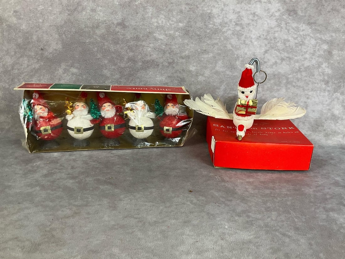 Shiny Brite New Old New Stock Christmas Decor: Five Santas measuring 4 inches tall. These have never been removed from the package, and were made in Japan. Original price stickers attached. Santa on a Stork ornament has staining on feathers and le