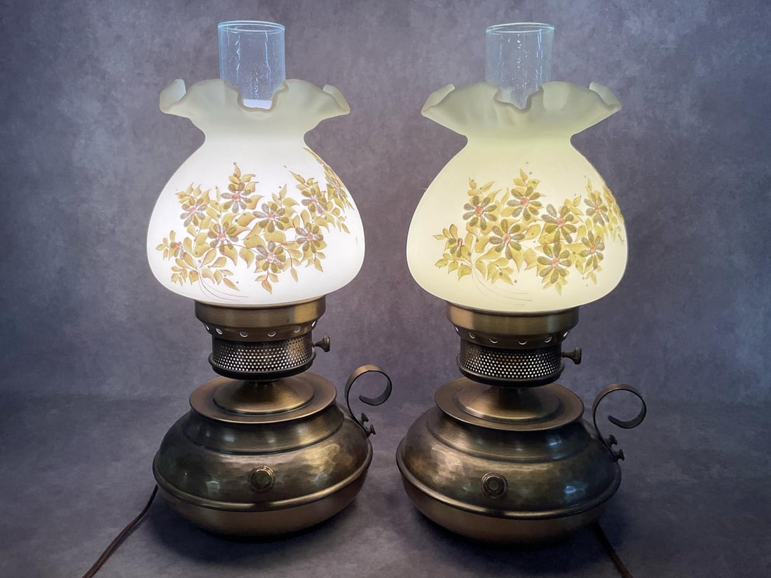 Fenton Colonial Satin Custard Glass Lamps: Signed Fenton Hand Painted B. Wilcox. Custard shades have sugar decoration of daisies with hand painted leaves. The shades are uranium and do fluoresce under black light. Brass bases. Both power on an