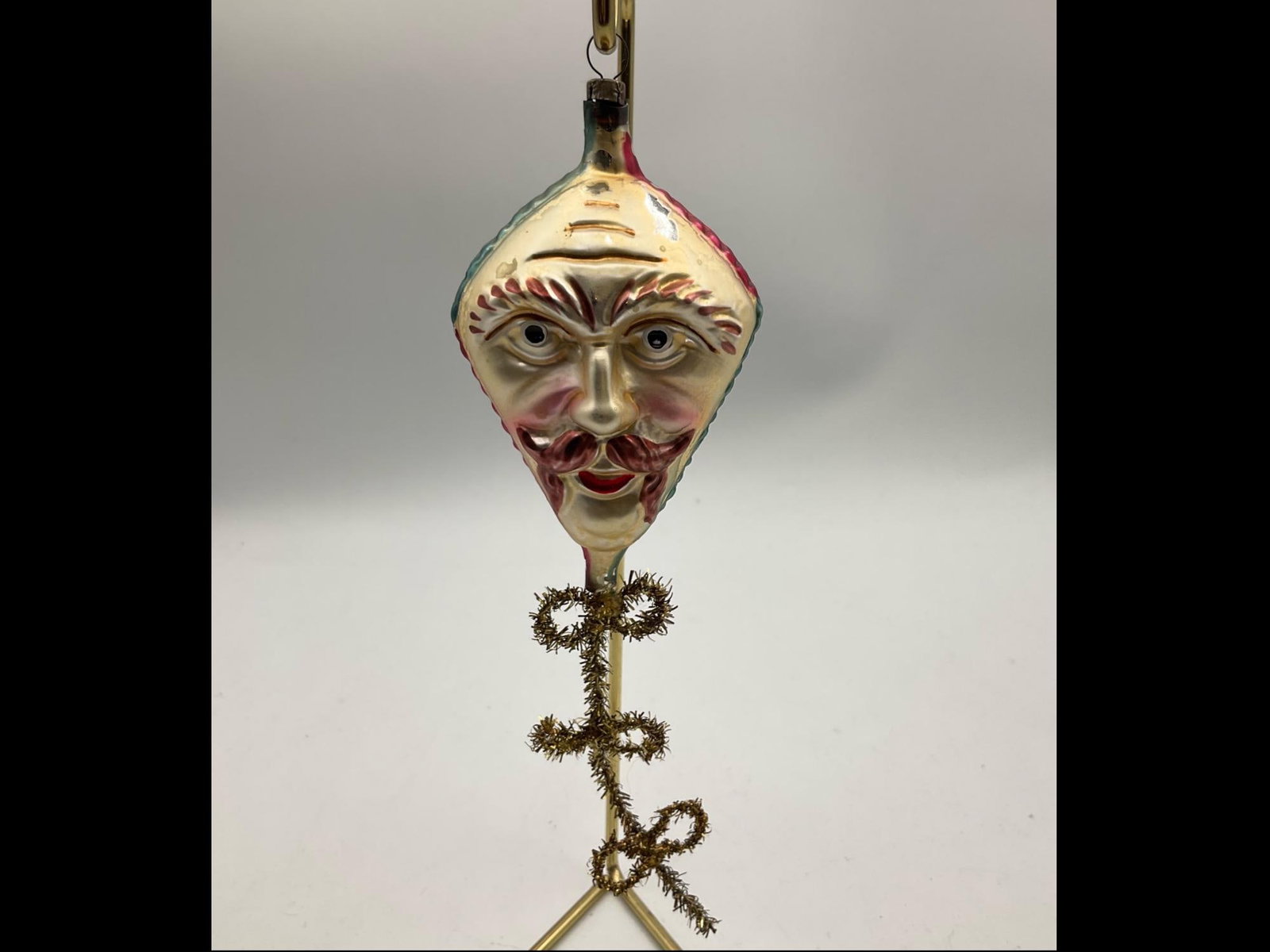 Kite Face Ornament: Believed to be Christopher Radko, but is missing tag. Ornament is 7.5 inches long. In fair to good condition with paint loss and scratches. Does not have original ornament hanger.