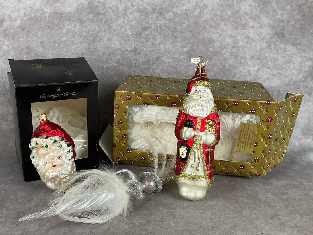 Designer Santas: Believed to be Christopher Radko Santa head, Dillards Trimmings German hand blown Santa, Italian De Carlini showgirl. All are in good condition, the showgirl is missing an arm. Boxes are in poor to fa