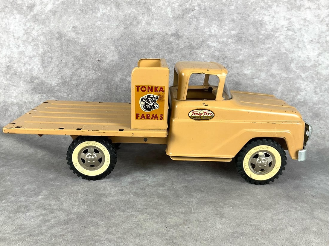 Tonka Farm Truck: 1960s pressed steel. Normal wear and rust throughout. Truck is missing racks that attach to the bed, front grill is damaged and two headlights are missing. Labels are in good shape. Truck measures 14.