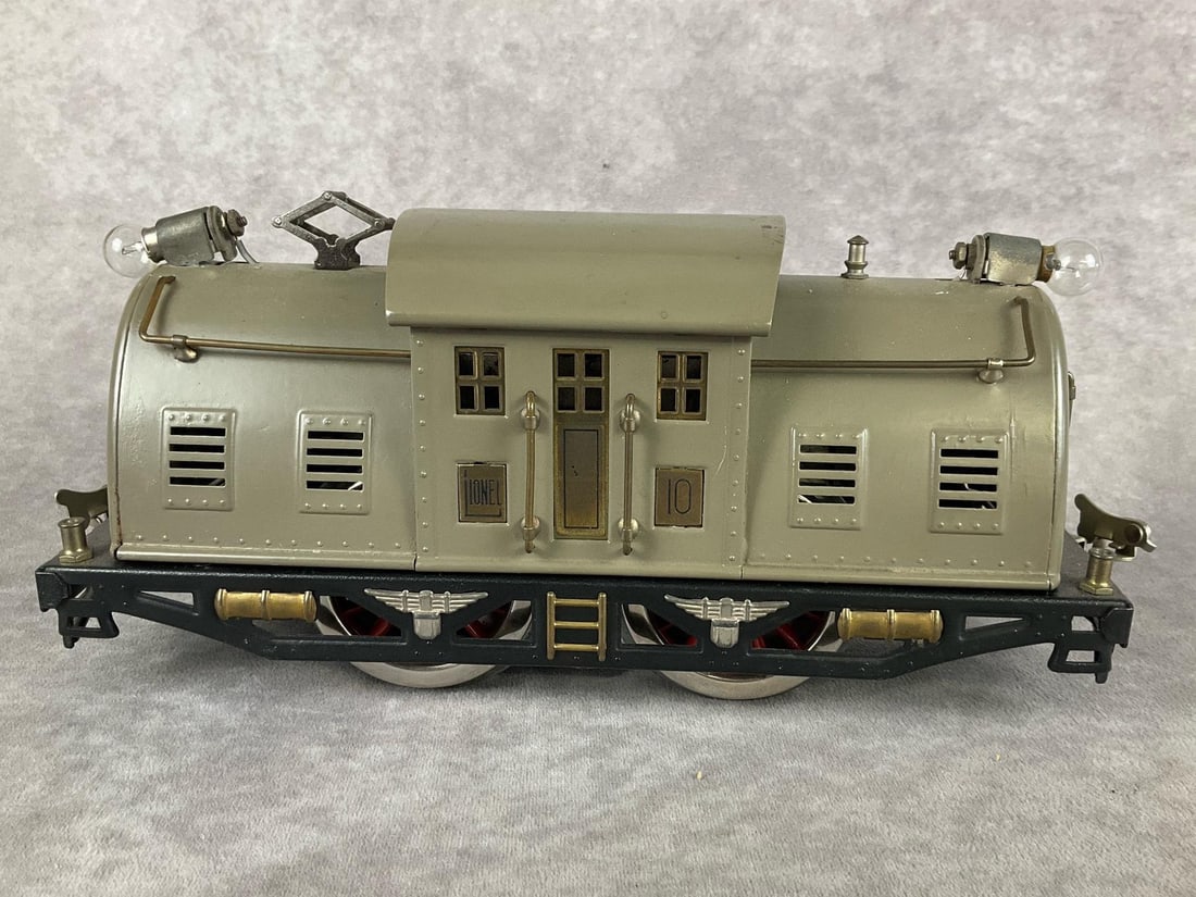Lionel No.10 Locomotive: Powered electric, standard gauge. Restoration has been done on this piece, black paint is painted over rust, and the wheels have been replaced. Missing Lionel name plaque and light covers on each end.