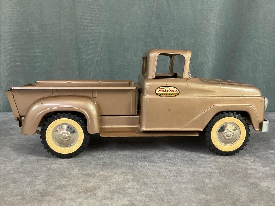 Tonka Toys Step Side Truck: Circa 1960 pressed steel. Plastic wheels, metal bumper, tailgate folds down. Original decals, scratches, and discolored headlights. 13x5.5x5. Fair to good condition.