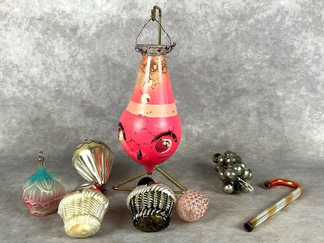 Victorian Mercury Glass Ornaments: Eight ornaments. Clown, double tier, grapes, two floral baskets, berries, and a rose. All are in fair to good condition for age. There is paint loss, fading and molting on most, along with damage to t