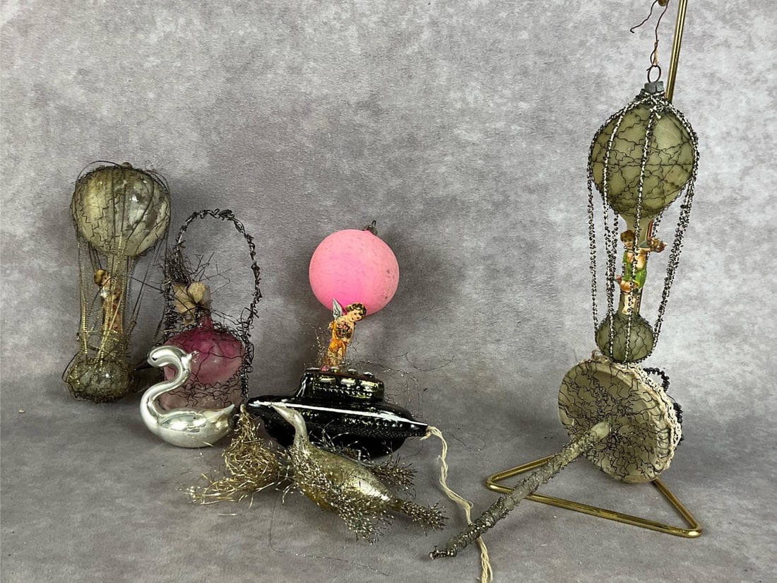 Free Blown Hot Air Balloon Ornaments: Early twentieth century. Group of eight. Two birds, three hot air balloons, a boat, umbrella, and decanter. All are in fair to good condition, with paint loss. One has missing wires. Tallest is 6 inch