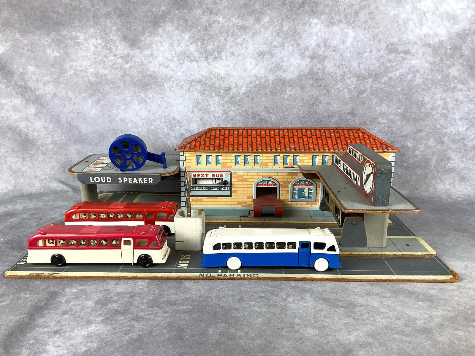 1950's Keystone Bus Station: Wood and cardboard bus station with loud speaker, untested. Destination wheel is in working order, as well as the traffic commuter, which turns. Includes three plastic busses, which are marked Keyston