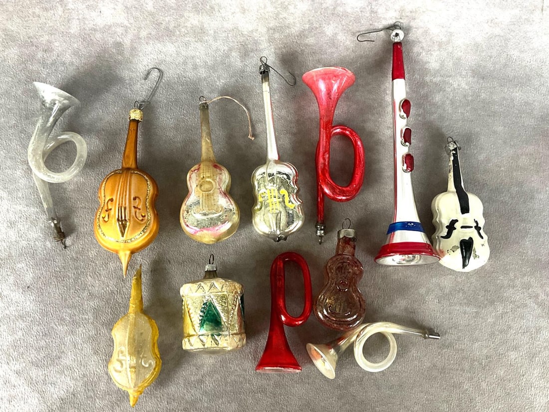 Musical Mercury Ornaments: Twelve total. Five horns, five stringed instruments, and one drum. Most are mercury glass. All are in fair to good condition with paint loss, and age. Some are missing their hangers. Longest ornament