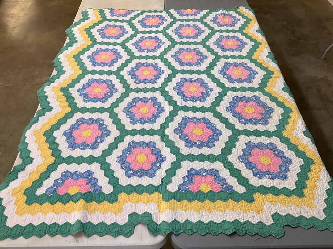 Hand Stitched Grandmother's Flower Garden Quilt: Softened colors from repeated washing. Several areas of lighter brown stains. 67 inches wide x 80 inches.