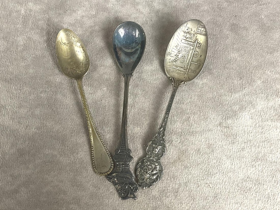 Souvenir Santa Spoons: Group of three. One is marked Sterling silver. All have Santa scenes on them. Tarnish and scratching on all. Longest spoon is 5 inches.
