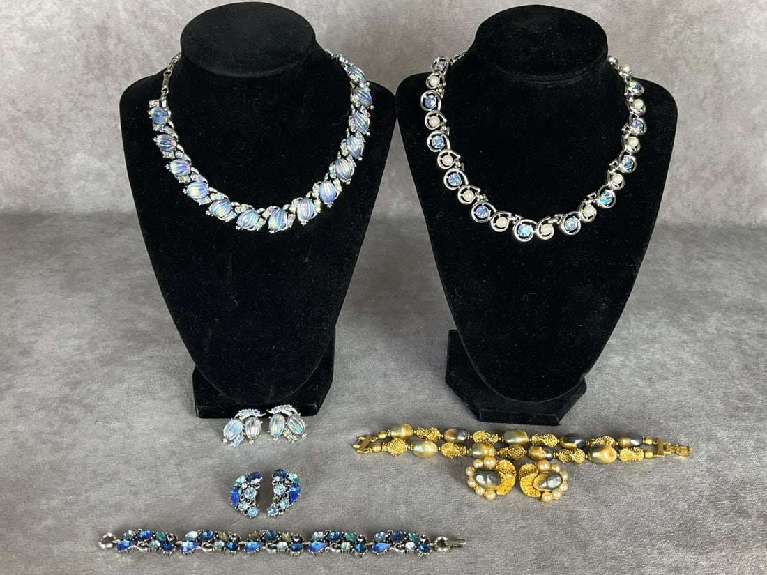 Signed Rhinestone Costume Jewelry: Coro melon bead necklace and matching earrings. Necklace is missing two stones. A larger stone has been poorly reglued. Trifari necklace with aurora borealis stones and faux pearls, missing one pearl.