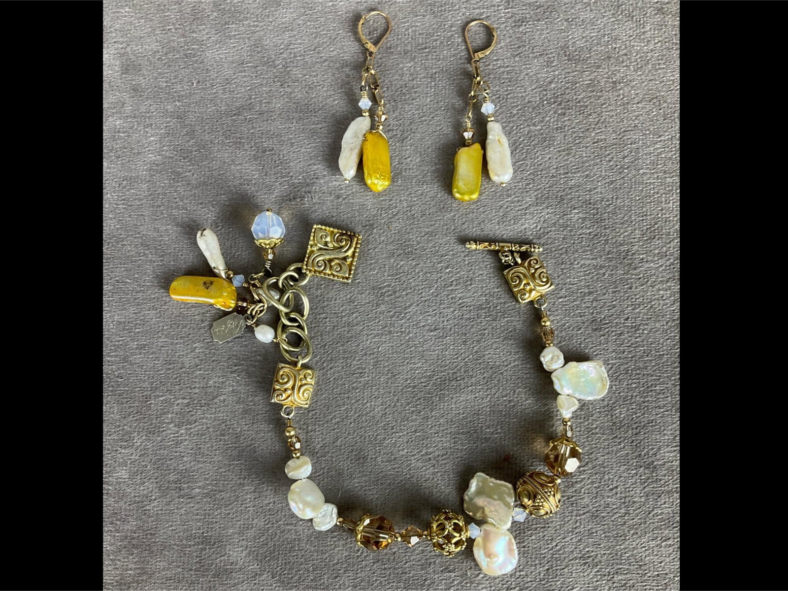 Tres Jolie Bracelet & Earrings: Freshwater pearls and topaz colored stones. Leverback earrings. Bracelet has metal Tres Jolie tag. 10 inches wide. Good condition.