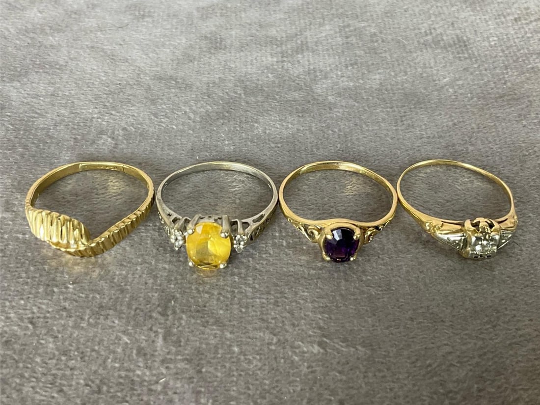 14k Gold Rings: Three are size 9. One of those has small diamonds, another is in white gold. Bands are thin and misshapen. Fourth ring is size 10 but the band is completely split. All marked 14k. Total weight of 7.9 